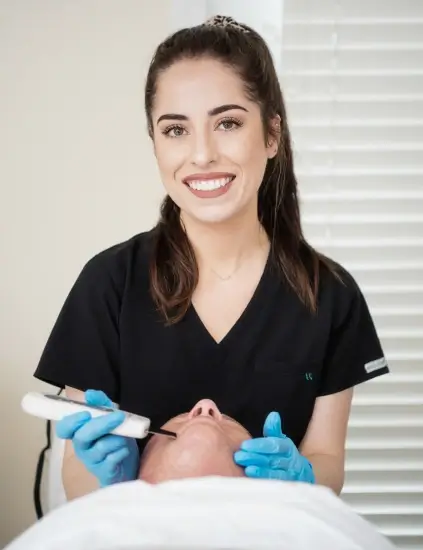 beauty and health institute woman receiving facial treatment from a doctor in a clinical setting